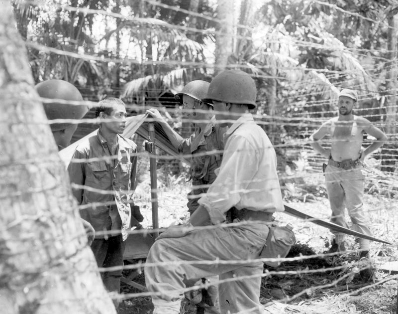 Major Burden and MIS sodlier interrogate a Japanese prisoner