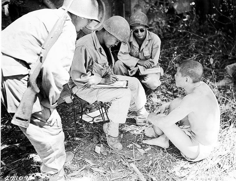 MIS soldiers interrogate Japanese prisoner.