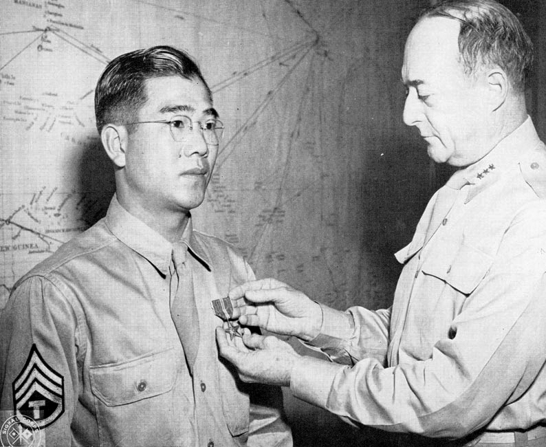 FORT SHAFTER, Hawaii, March 1945: Seian Hokama of Honolulu receives the Bronze Star from Lieutenant General Robert Richardson, U.S. Army Forces Pacific Ocean Areas commander.
