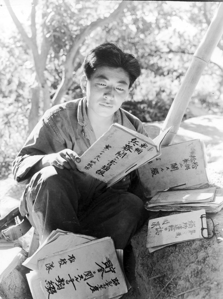 MIS soldier reading captured Japanese military documents.